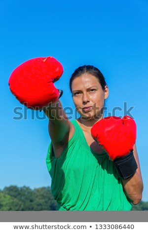 Foto stock: Young Woman Wearing Red Boxing Gloves With Blue Sky