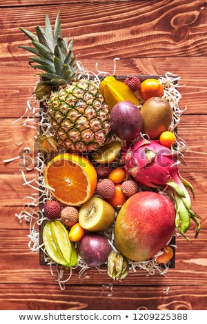 Foto stock: Exotic Mix From Ripe Fresh Fruits - Pineaple Dragon Fruit Mango Coconut Kiwi Carambola Litchi