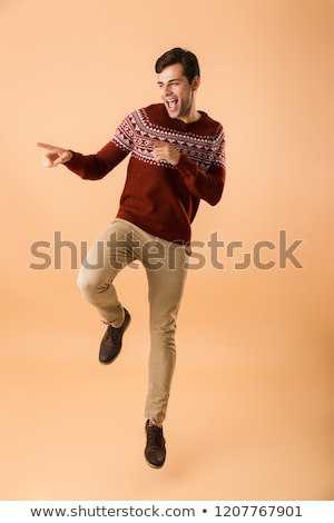 Zdjęcia stock: Image Of Young Man 20s With Bristle Wearing Knitted Sweater Poin