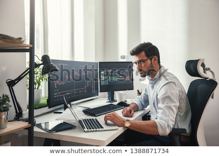 Сток-фото: Stock Trader Sitting At Workplace