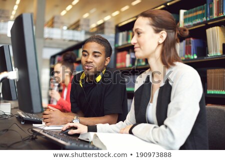 Foto stock: Young Men Working On Their Assignments In A Computer Lab