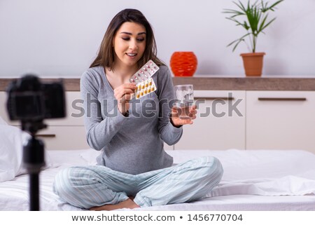 Woman Showing Pills In Her Bedroom Imagine de stoc © Elnur