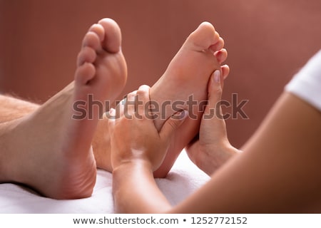 Stock photo: Fingers Of A Physiotherapist Pressing On A Foot In A Room