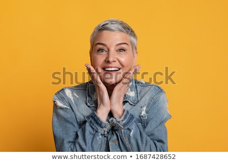 Stock photo: Mature Woman Standing With Her Hand On Chin
