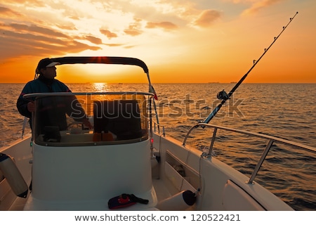 Stock photo: Sunrise Fishing Boat Blue Sea Orange Sky