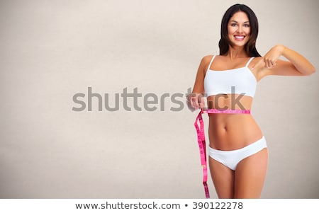 Сток-фото: Woman Waist With Measuring Tape Over Gray Background