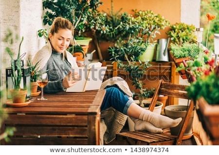 Foto stock: Girl With Plant In Green House