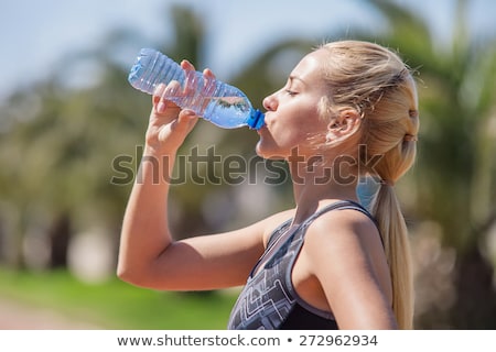 Stok fotoğraf: Woman Drinking Water During Workout