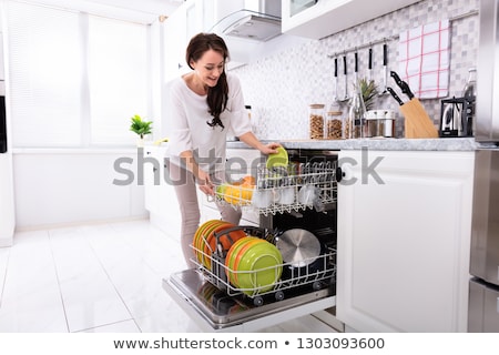 Сток-фото: Woman Arranging Plates In Dishwasher