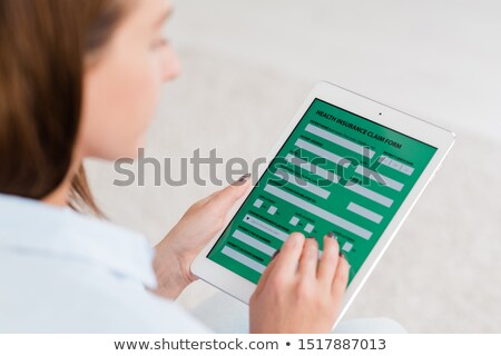 Stock foto: Young Woman Holding Digital Tablet With Electronic Form Of Health Insurance