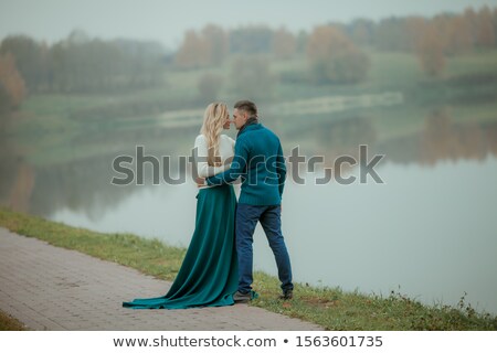 Stok fotoğraf: A Heterosexual Couple In Love Hugs And Walk Near The Citys Natural Lake