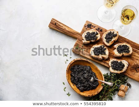Stockfoto: Sturgeon Black Caviar In Wooden Bowl Sandwiches And Champagne On White Background Copy Space