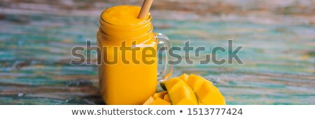 Foto stock: Glass Of Mango Smoothie With Bamboo Drinking Straw Exotic Vacation Chill Out Drink Concept Banner