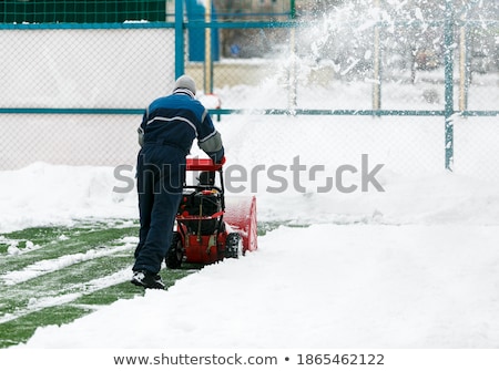 Zdjęcia stock: Man Using Snow Blower On Snowy Drive