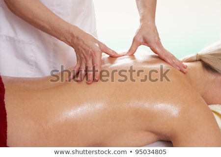 Stok fotoğraf: Woman With Tattoo Having Shoulder Massage