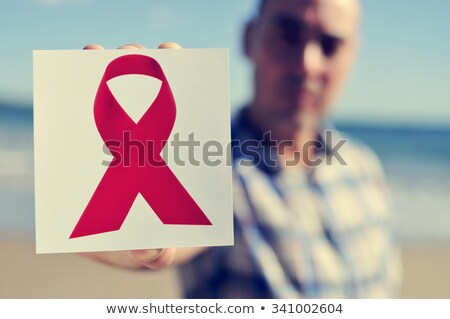 Young Man With A Picture Of A Red Ribbon For The Fight Against A Foto stock © nito