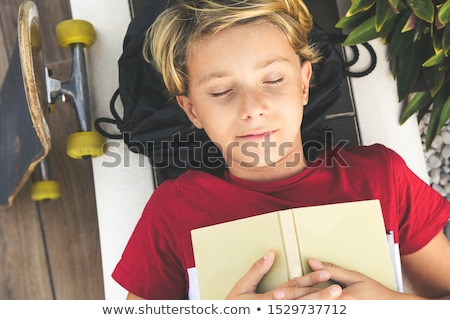 Stockfoto: Young Boy Lying Dreaming Of A Summer Vacation