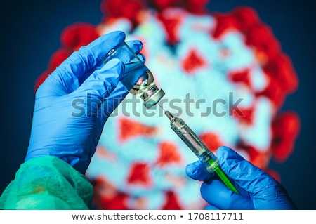 Foto stock: Doctor Drawing Up Solution And Filling Syringe