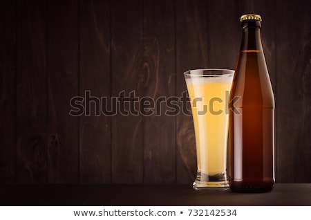 Stock photo: Pilsner Beer Glass With Muddy Weizen On Dark Wood Board Copy Space