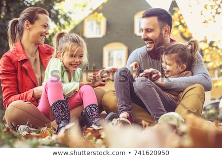 Stock photo: Happy Family Playing With Autumn Leaves At Park