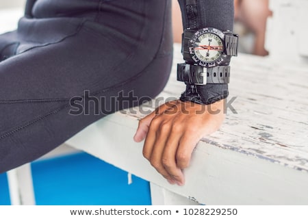 Foto stock: Young Diver Preparing An Underwater Compass For Diving