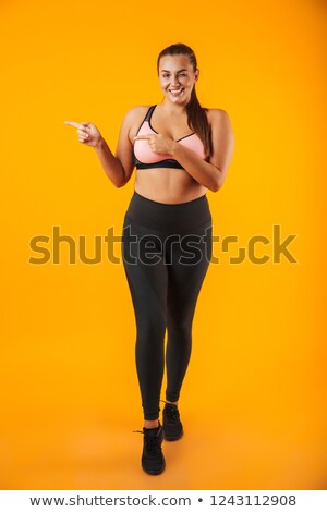 Foto stock: Full Length Portrait Of Overweight Woman In Sportive Bra Smiling