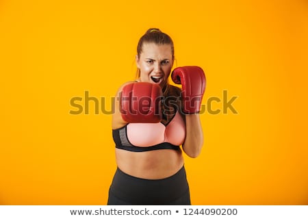 [[stock_photo]]: Portrait Of Strong Big Sportswoman In Sportive Bra Wearing Boxin