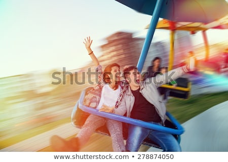 Stok fotoğraf: Beautiful Young Woman Having Fun At An Amusement Park