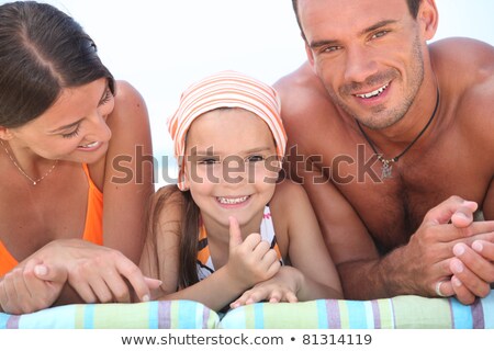 Zdjęcia stock: Happy Young Family Lying On The Sandy Beach