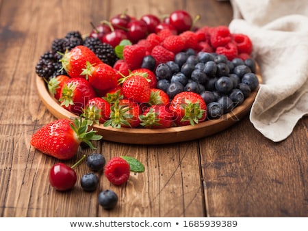 Stok fotoğraf: Fresh Organic Summer Berries Mix In Round Wooden Tray On Light Wooden Table Background Raspberries