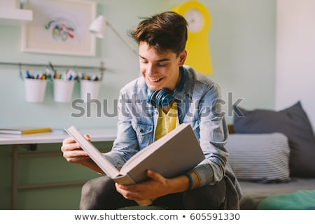 Zdjęcia stock: Student Boy Reading Book At Home Table