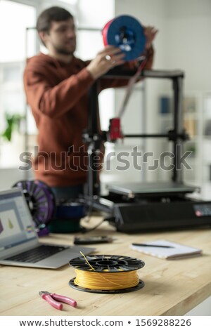 Stok fotoğraf: Spool With Yellow Filament And Nippers On Workplace Of Creative Designer