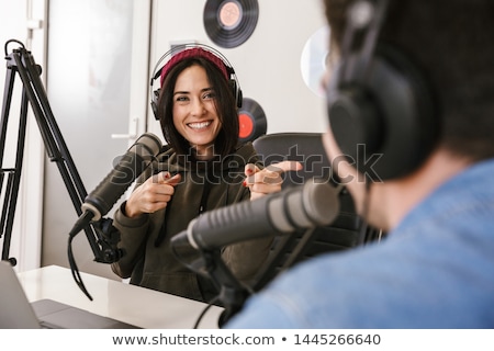 Stockfoto: Woman With Microphone Recording Podcast At Studio