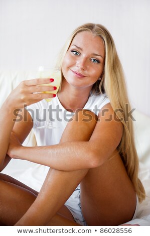 Foto stock: Woman Drinking Fresh Ice Tea Beverage And Looking At Camera Whil