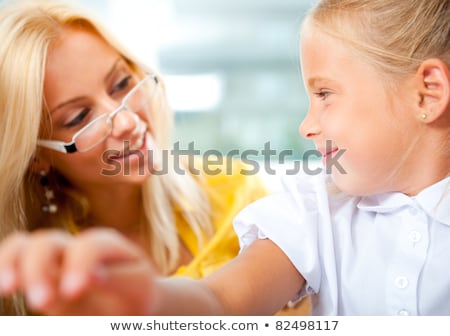 Stockfoto: Young Pretty Teacher Helping To Her Students To Make Exercise In