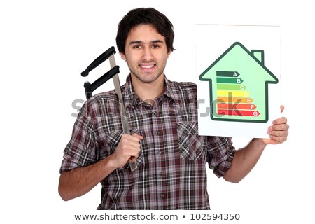 Stockfoto: Man Holding Calipers And Information About Energy Efficiency