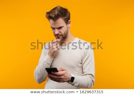 Foto stock: Confused Young Man On The Phone