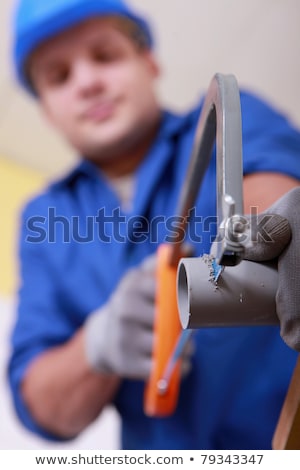 [[stock_photo]]: Plumber Sawing Plastic Pipe