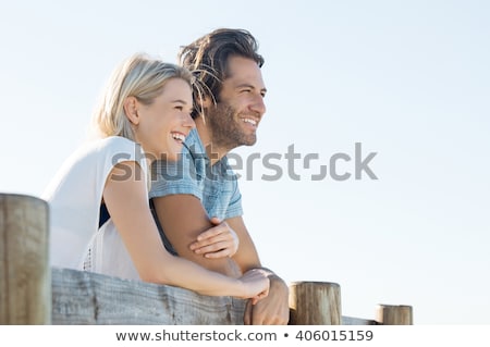 Stock fotó: Young Smiling Couple Looking Away