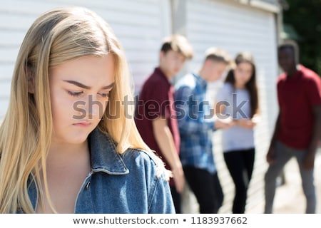 Foto stock: Unhappy Teenage Girl Being Gossiped About By Peers