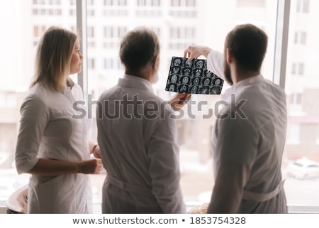 Сток-фото: Doctor Holding Mri Xray And Talking To Patient