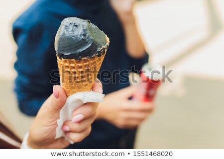 Foto stock: Closeup Of Attractive Young Woman Biting Lip With Black Lipstick