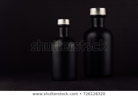 Stock fotó: Dark Black Minimalist Interior Blank Black Cosmetics Bottles On Dark Wood Board With Copy Space