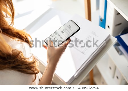 Stock fotó: Businesswoman Taking Photo Of Bill With Mobile Phone