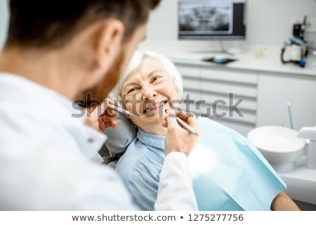 Stok fotoğraf: Woman Dentist Working On Teeth Implant