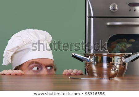 Stock fotó: Funny Young Chef Strange Looking At Pot