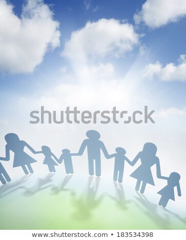 Foto stock: Paper Family In Hand Sun And Blue Sky