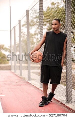 Stock foto: African Basketball Player Standing In Park While Looking Aside