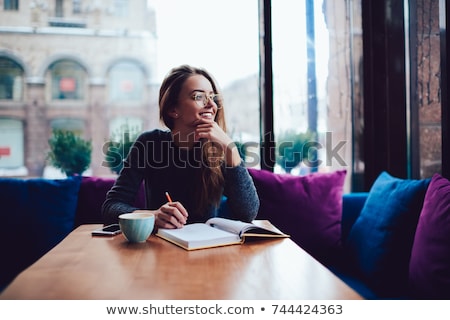 Stockfoto: Smiling Pretty Woman Sitting At The Cafeteria