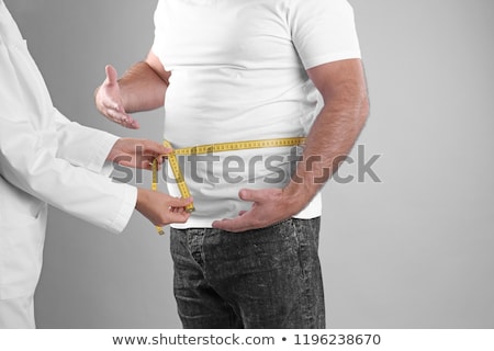 Foto stock: Man Weight Loss Measure Waist